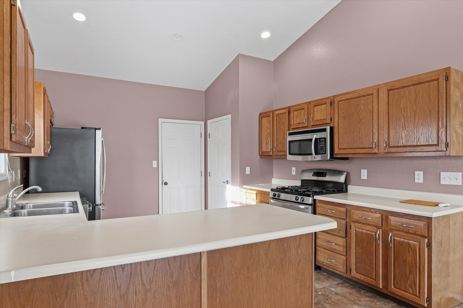 606 Cedar Drive St. Joseph, IL 61873 - Photo 13 of 32 a kitchen with stainless steel appliances a stove microwave and sink