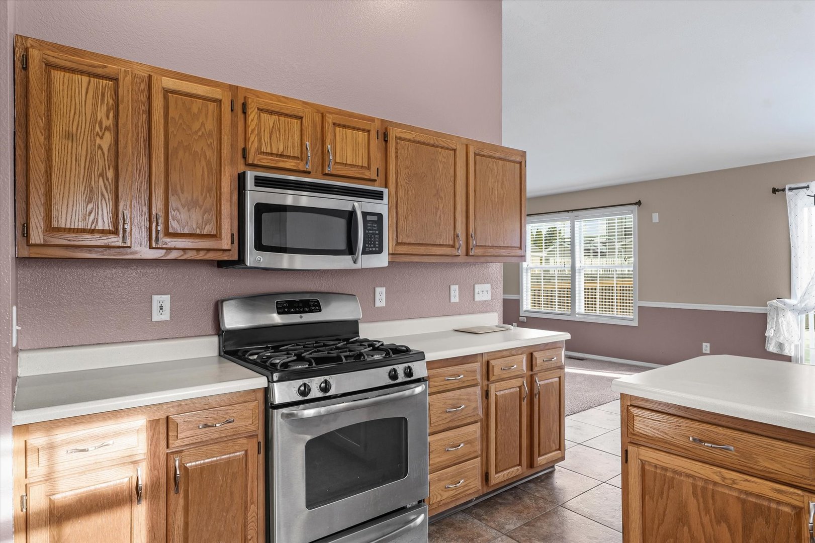 606 Cedar Drive St. Joseph, IL 61873 - Photo 16 of 32 a kitchen with stainless steel appliances granite countertop a stove microwave and cabinets
