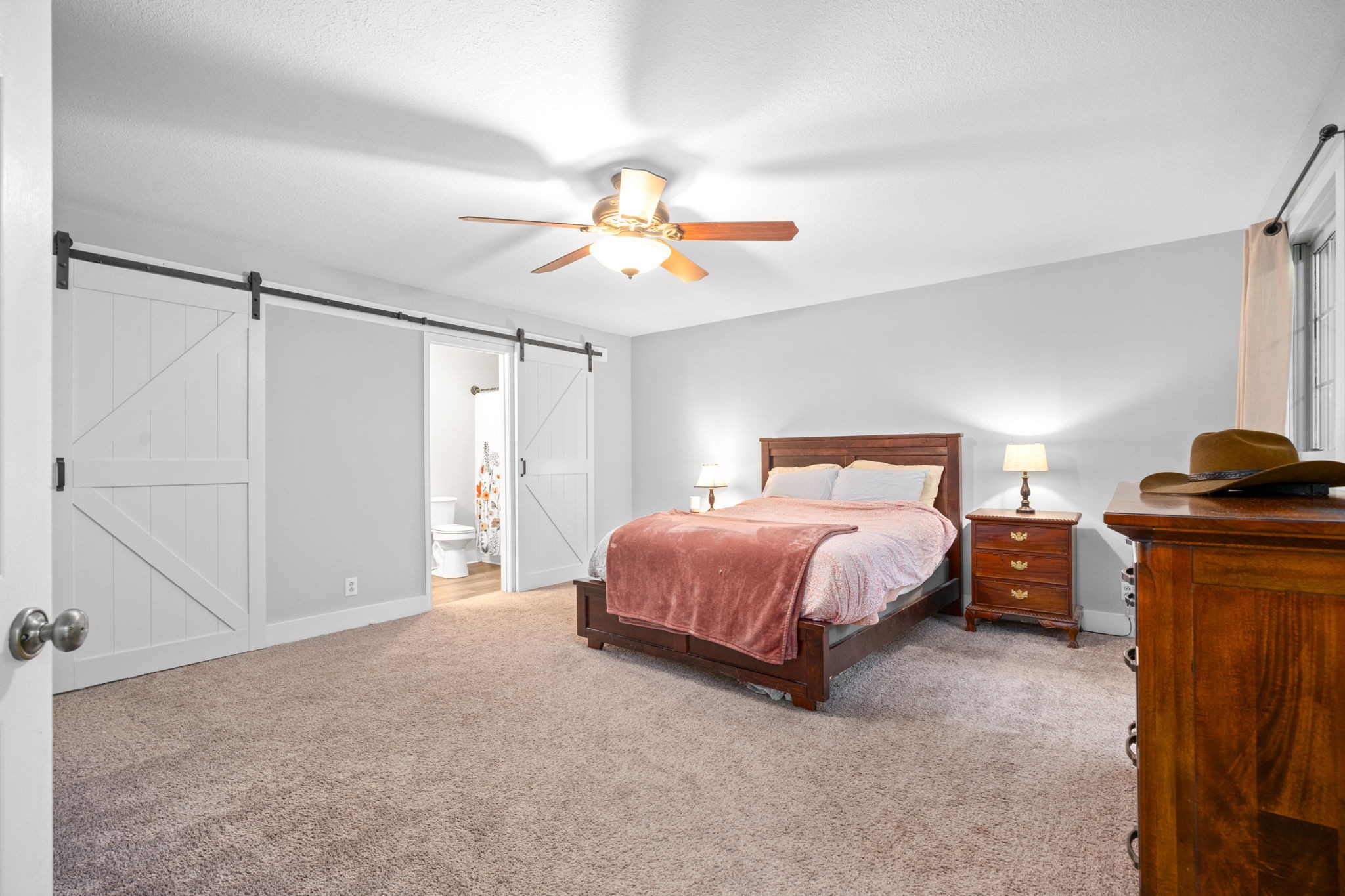 1925 7 Mile Ferry Road Clarksville, TN 37040 - Photo 25 of 57 a spacious bedroom with a bed and a chandelier