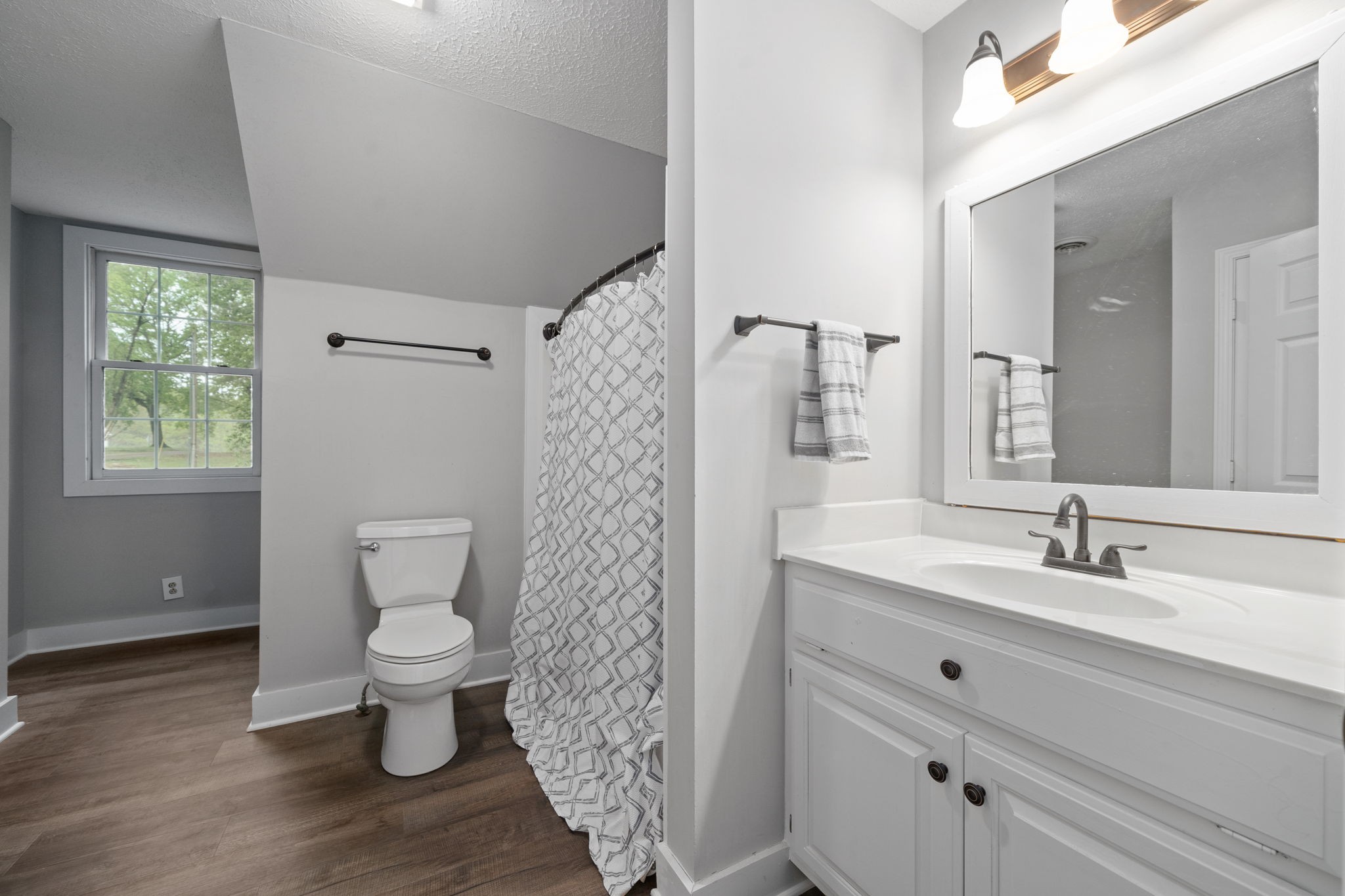 1925 7 Mile Ferry Road Clarksville, TN 37040 - Photo 33 of 57 a bathroom with a sink toilet a mirror and shower