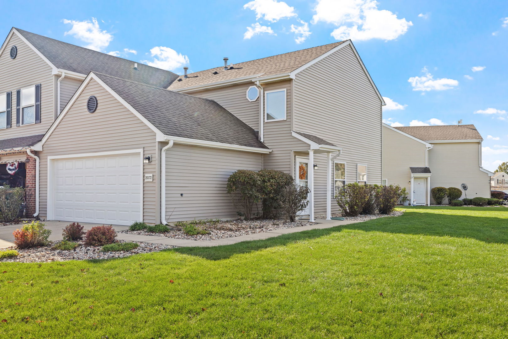25172 Faraday Road, Unit 1 Manhattan, IL 60442 - Photo 1 of 25 a backyard of a house with table and chairs