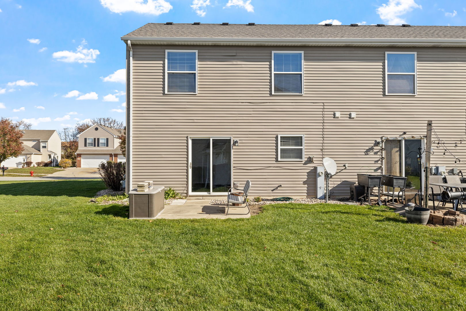 25172 Faraday Road, Unit 1 Manhattan, IL 60442 - Photo 3 of 25 a backyard of a house with table and chairs