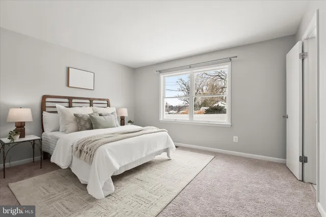 a spacious bedroom with a bed and a window
