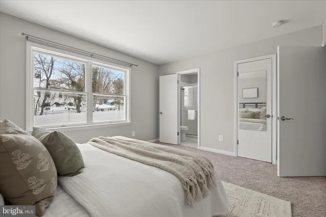 a bedroom with a large bed and a window