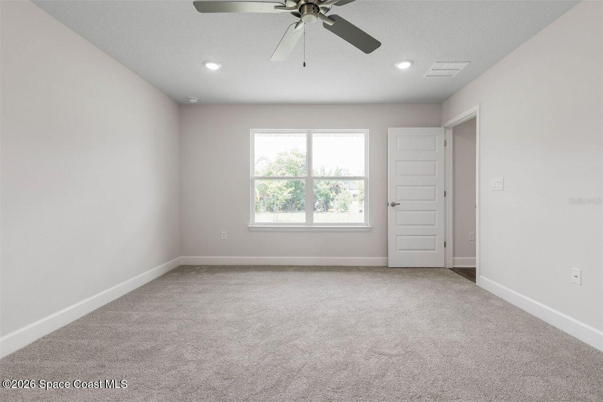 962 Seneca Avenue Sebastian, FL 32958 - Photo 12 of 28 an empty room with a window and a ceiling fan
