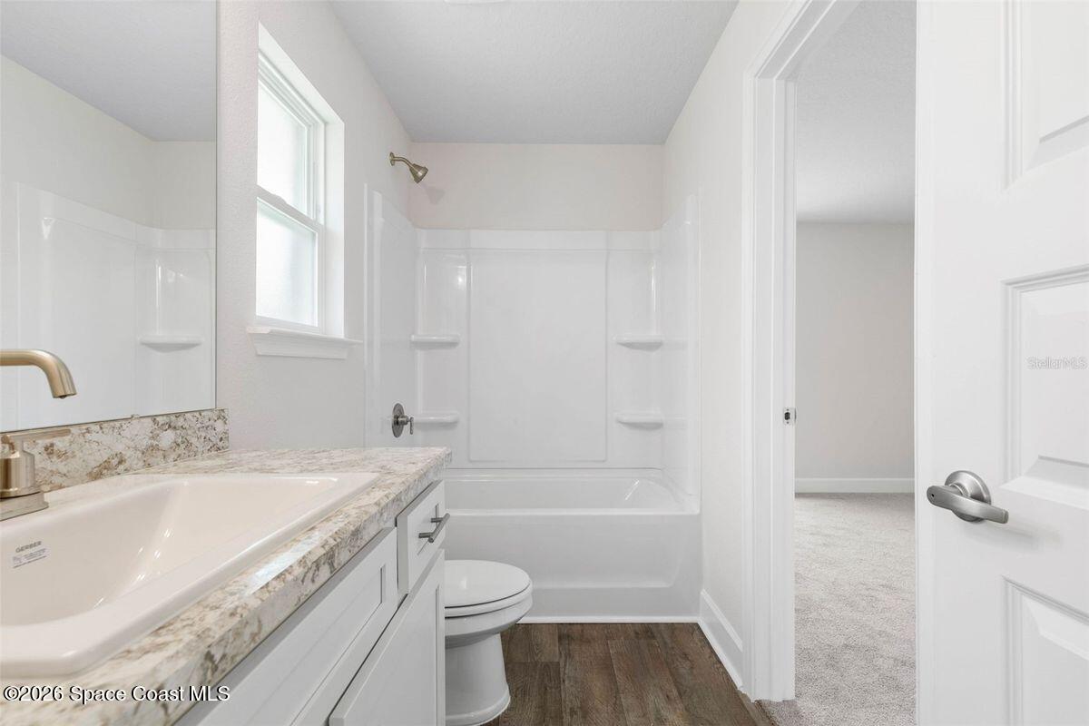 962 Seneca Avenue Sebastian, FL 32958 - Photo 22 of 28 a bathroom with a granite countertop sink a toilet and shower