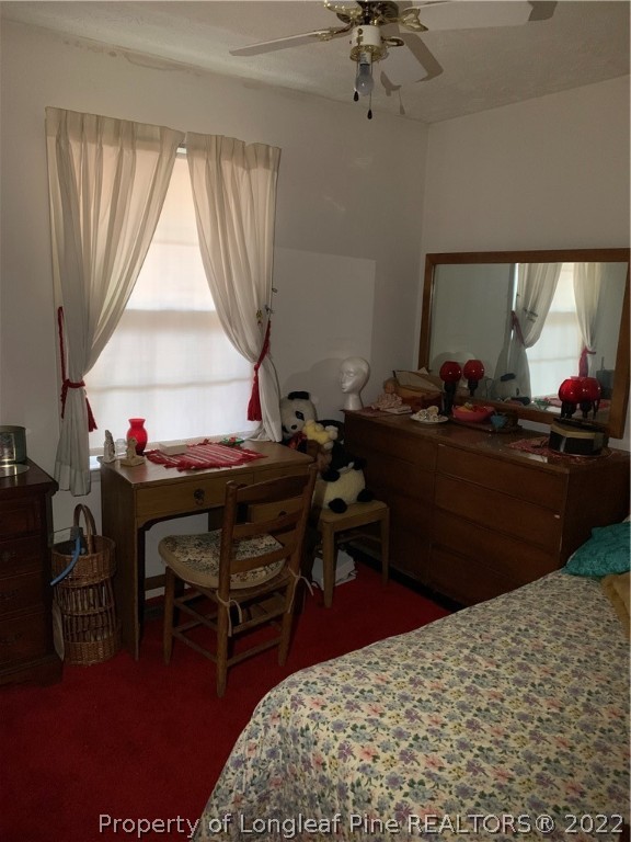 1231 Loop Road Raeford, NC 28376 - Photo 5 of 11 a bed room with a bed and a table