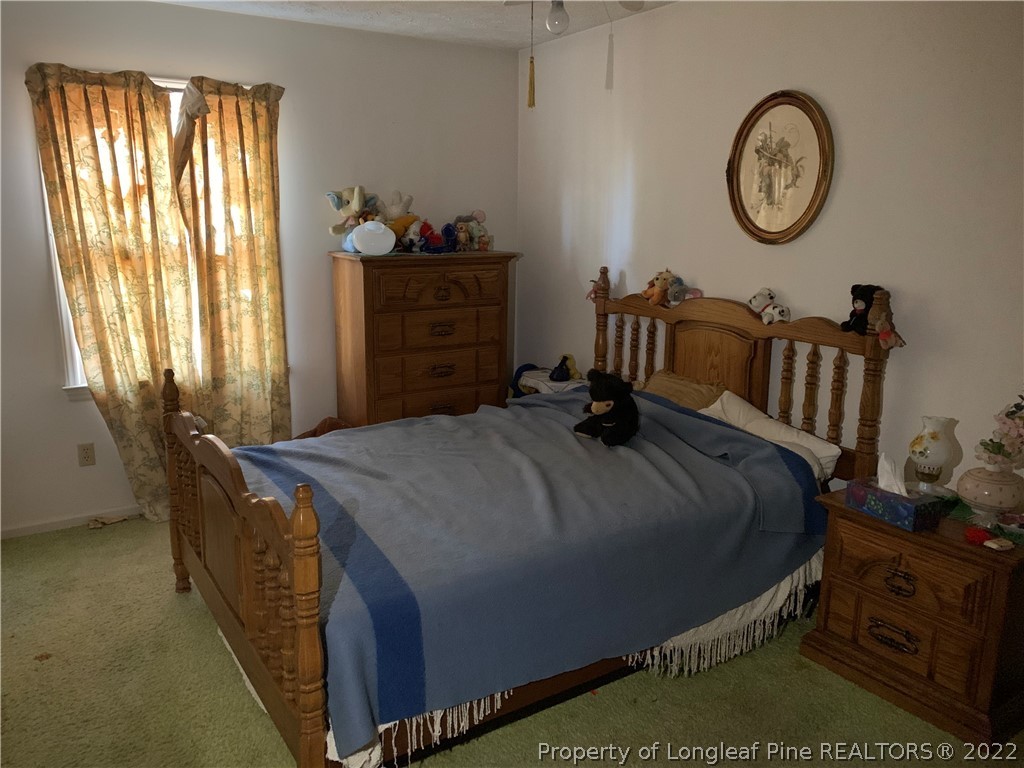 1231 Loop Road Raeford, NC 28376 - Photo 9 of 11 a bed sitting in a bedroom next to a window