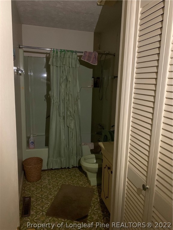 1231 Loop Road Raeford, NC 28376 - Photo 10 of 11 a bathroom with a shower and a toilet