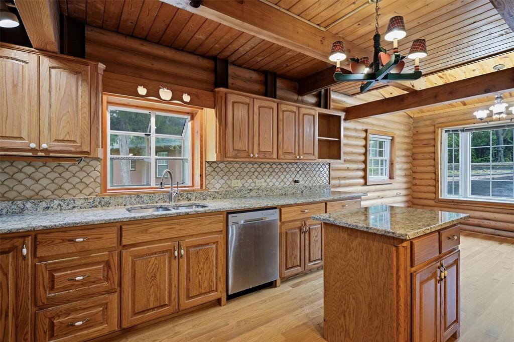 570 Ayres Road Bells, TX 75414 - Photo 15 of 40 a kitchen with granite countertop cabinets a sink a window and stainless steel appliances