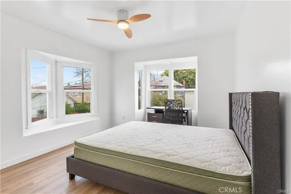a bedroom with a large bed and a large window