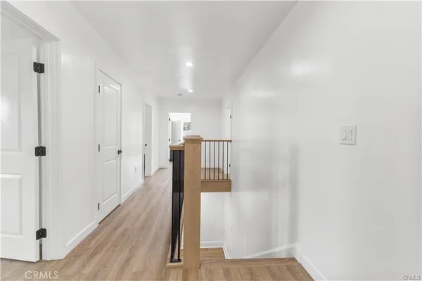 a view of hallway with wooden floor