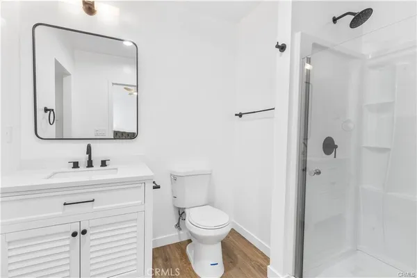 a bathroom with a toilet sink vanity and mirror