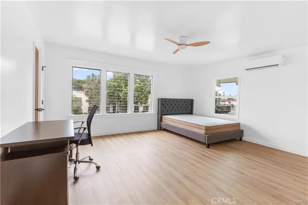 a bedroom with a bed and a desk