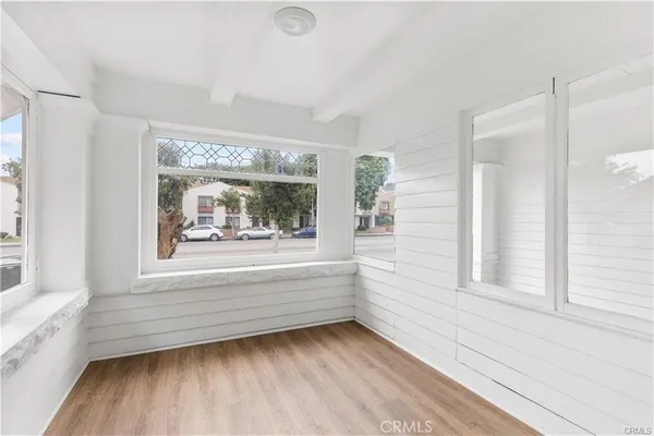 a view of lot of window and wooden floor