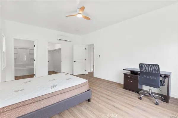 a spacious bedroom with a bed and a desk