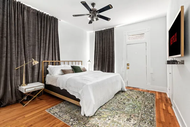 a bedroom with a bed and a flat screen tv