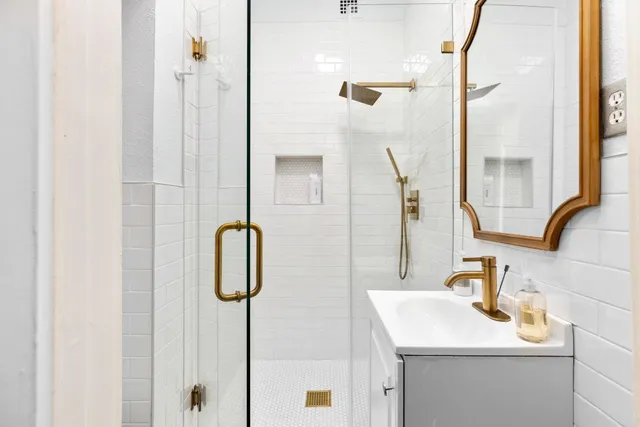 a bathroom with a sink vanity and a mirror