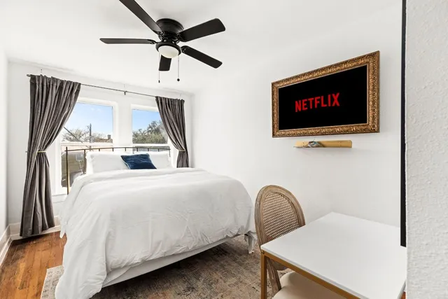 a bedroom with a bed and a flat screen tv