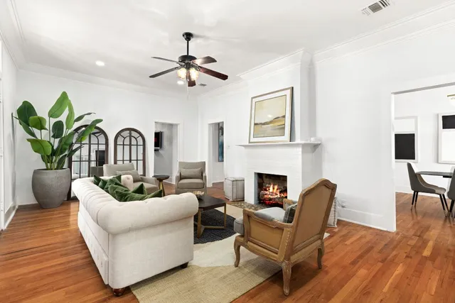 a living room with furniture a fireplace and wooden floor
