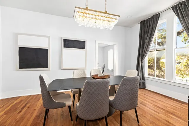 a view of a dining room with furniture wooden floor and chandelier
