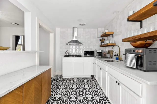 a kitchen with stainless steel appliances granite countertop a sink and cabinets
