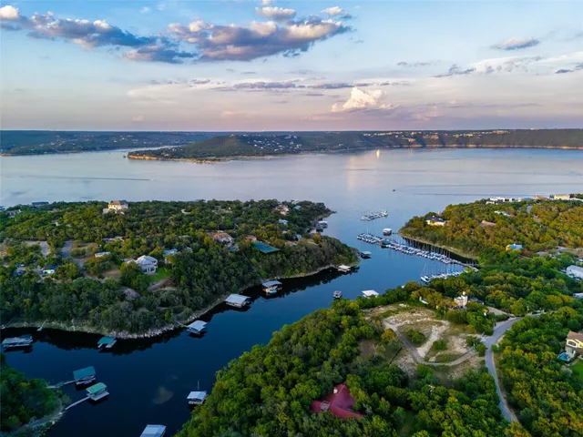a view of a lake with houses in the back