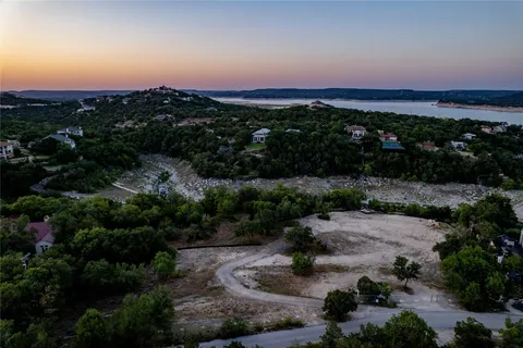 a view of a lake with sunset in background