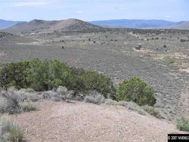1240 Columbia Hill Road Reno, NV 89508 - Photo 1 of 9 a view of a dry field with mountains in the background