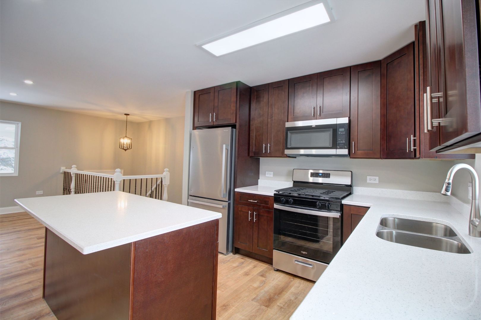225 Haller Avenue Romeoville, IL 60446 - Photo 6 of 19 a kitchen with stainless steel appliances a stove a sink a microwave and refrigerator