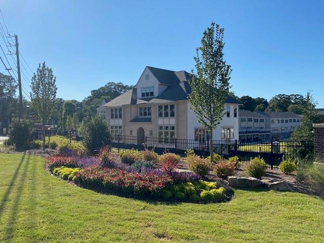 a view of a house with swimming pool a yard and a patio