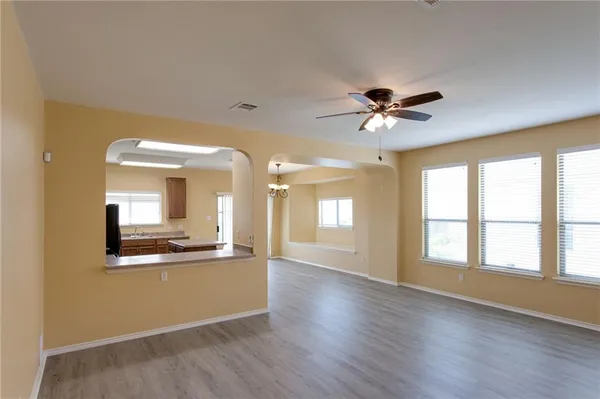 a view of a kitchen with a dishwasher cabinets and a large window