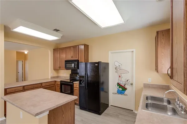 a kitchen with stainless steel appliances granite countertop a refrigerator and a stove
