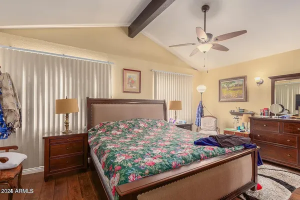 a bedroom with a bed and wooden floor