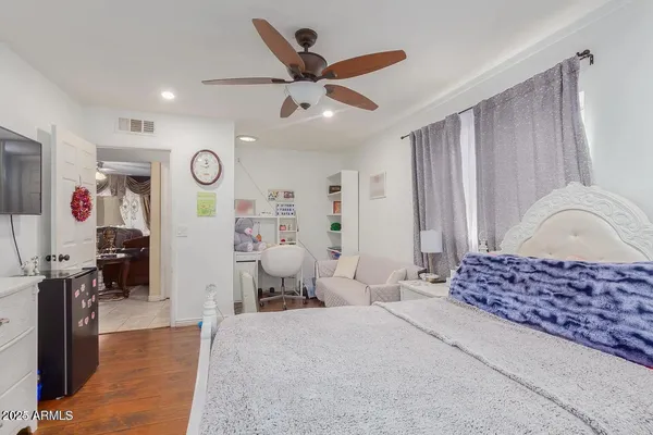 a bedroom with a bed dresser and a window