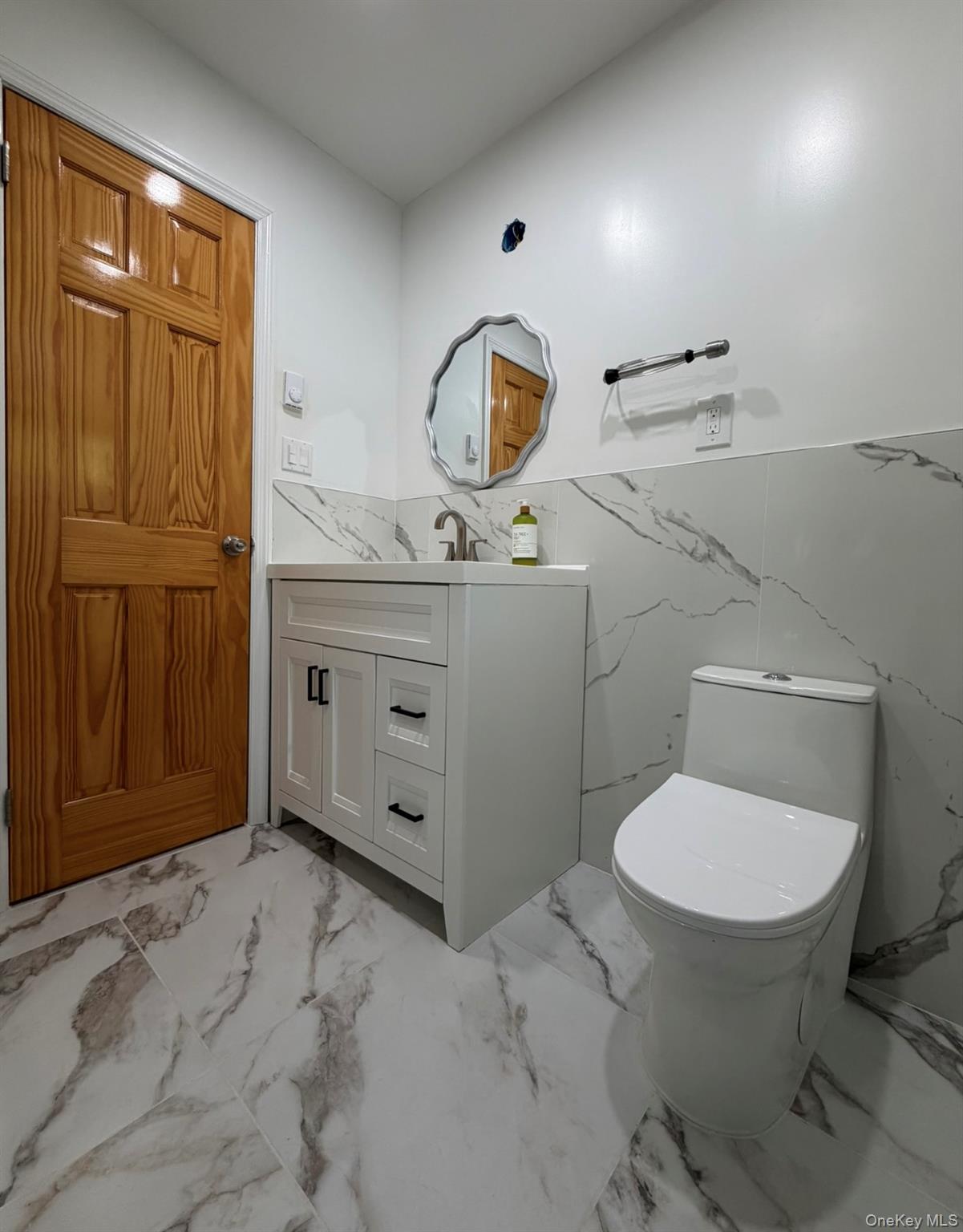 60 Medallion Road Kiamesha Lake, NY 12751 - Photo 27 of 44 a bathroom with a toilet a sink and mirror