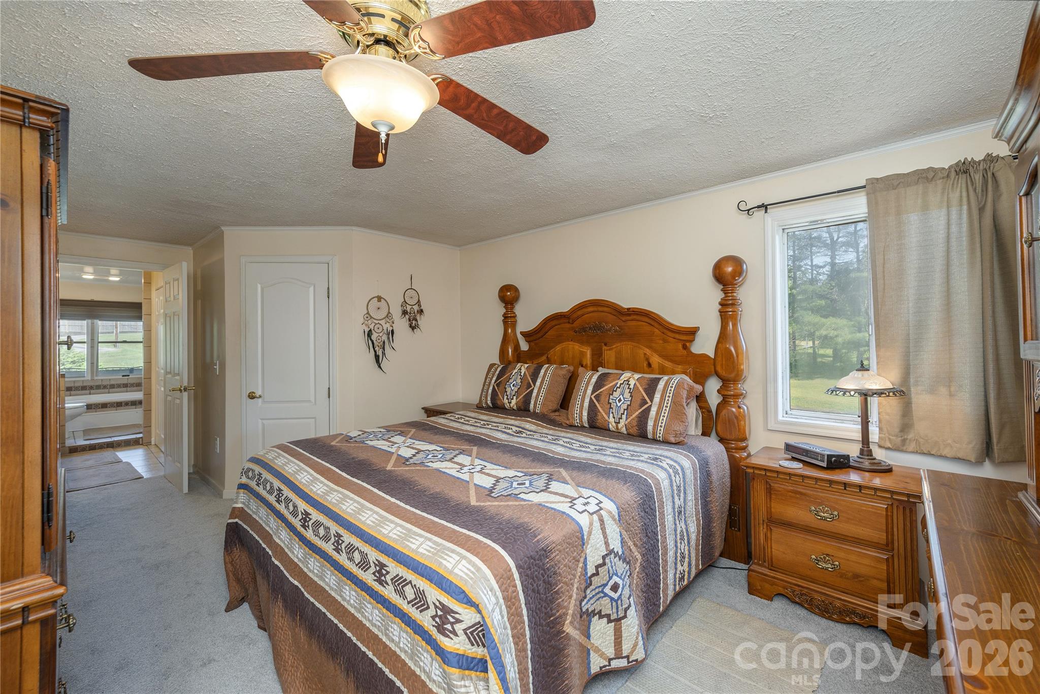 231 Allen Road East Flat Rock, NC 28726 - Photo 19 of 42 a bedroom with a bed and a chandelier