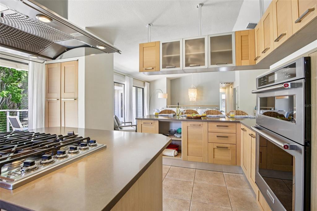 3390 Bayou Sound Longboat Key, FL 34228 - Photo 19 of 59 a kitchen with kitchen island granite countertop a sink cabinets and stainless steel appliances
