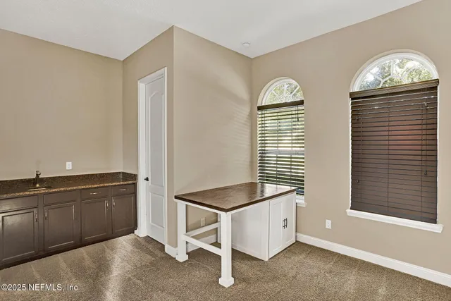 a spacious bathroom with a granite countertop sink and a window