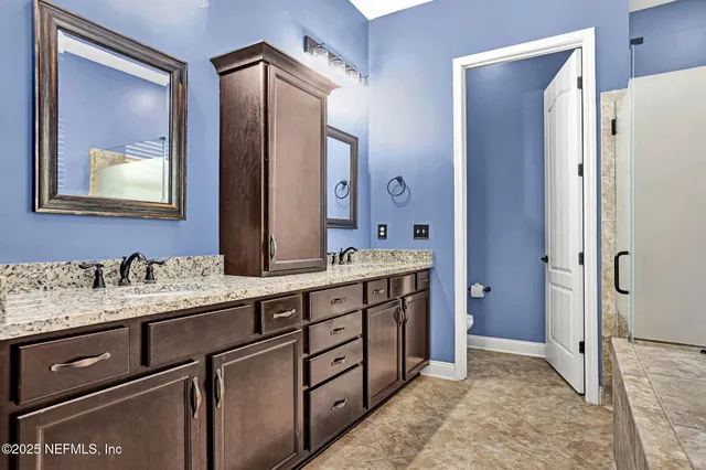 a bathroom with a double vanity sink mirror and double