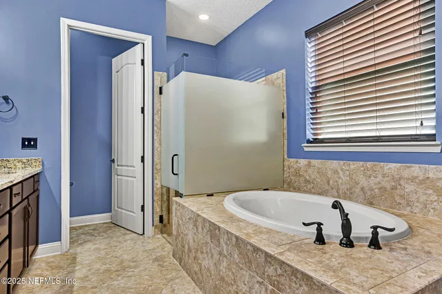 a bathroom with a tub and a window