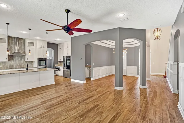 a view of a kitchen with wooden floor and a kitchen