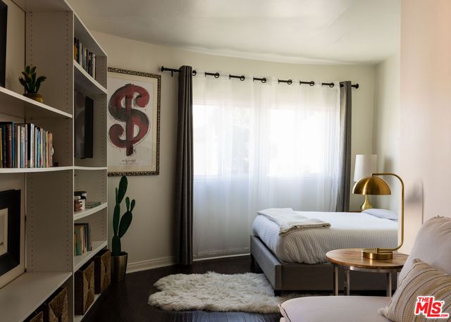 a bedroom with furniture and a window