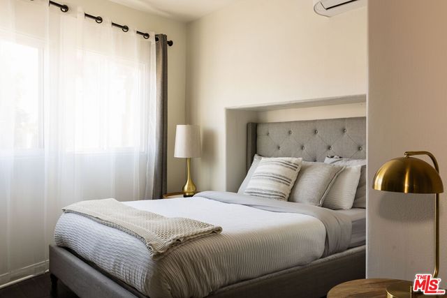 a bedroom with a bed and a mirror