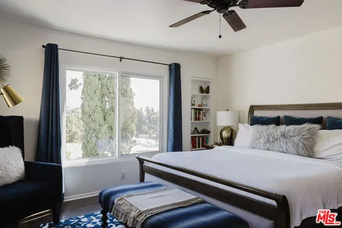 a bedroom with a large bed and a window