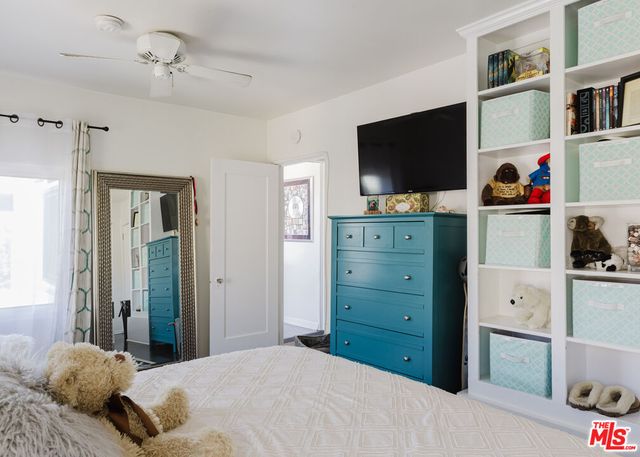 a bedroom with a bed and flat screen tv