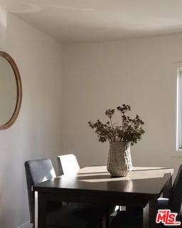 a bedroom with a bed a couch and potted plant