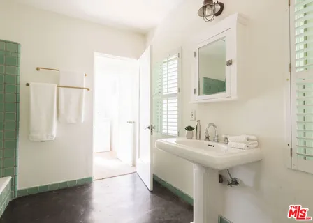 a bathroom with a bathtub and shower