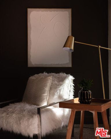 a view of living room filled with furniture and a potted plant