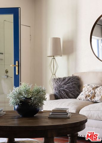 a bed room with a bed and a painting on the wall